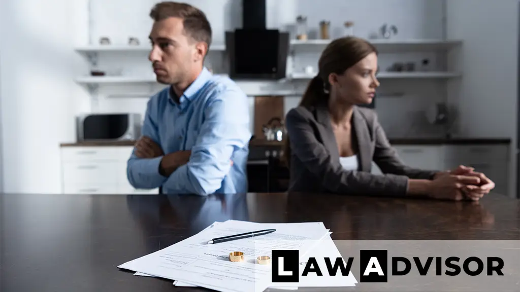 Couple sitting at table with divorce documents, symbolizing separation and legal proceedings