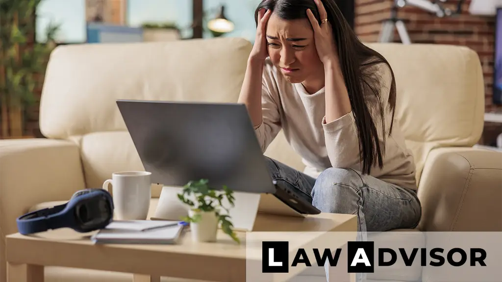 Young woman holding her head with eyes closed, experiencing a headache or stress from medical billing issues