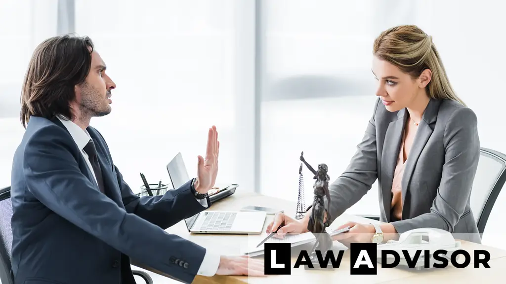 Businessman consulting a lawyer while reviewing a contract and documents at the office desk