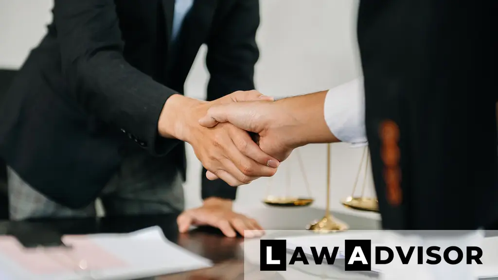 Female lawyer and client shaking hands after discussing estate planning or legal arrangements.