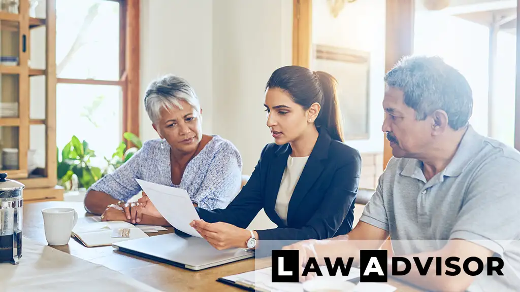 Woman guiding older couple through retirement and estate planning