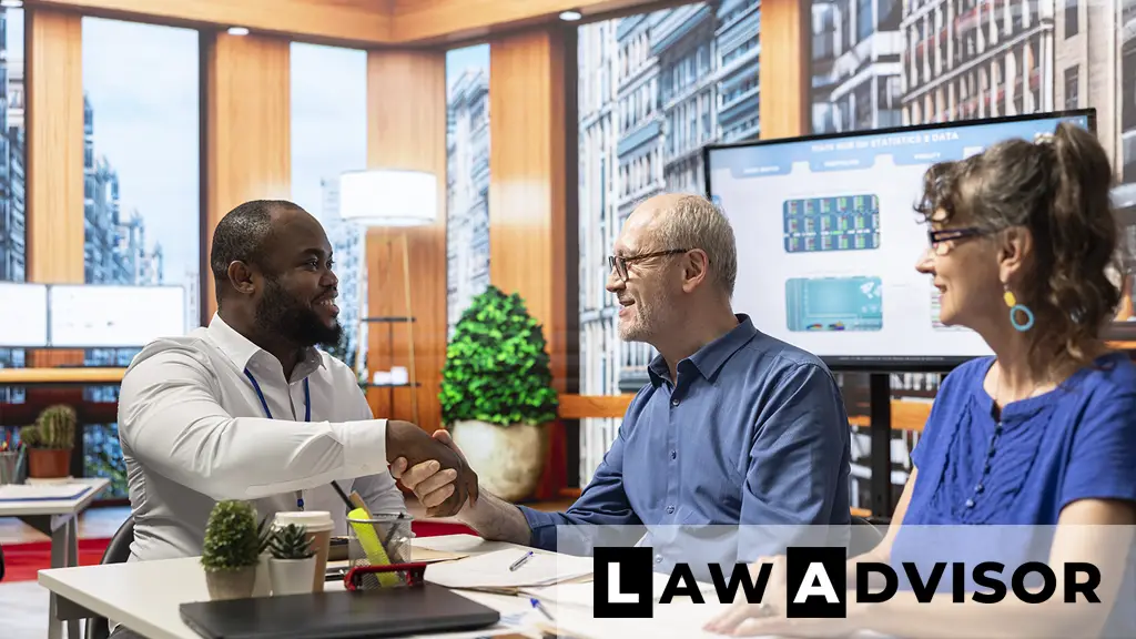 Insurance client shaking hands with an advisor, symbolizing agreement on a personal injury settlement offer.