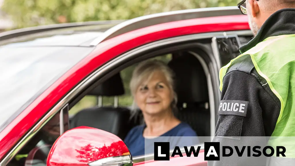 Police officer speaking with an elderly woman during a traffic stop, representing respectful questioning and Miranda warning scenarios.