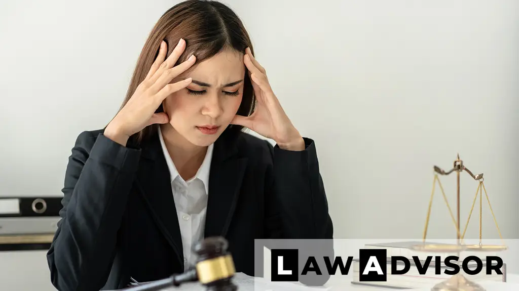 Stressed business lawyer with a headache reviewing documents
